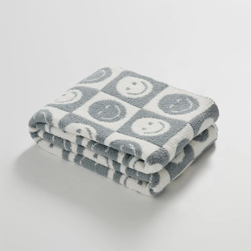 SnuggleJoy – Hyggeligt tæppe med ternet mønster og smil emoji design